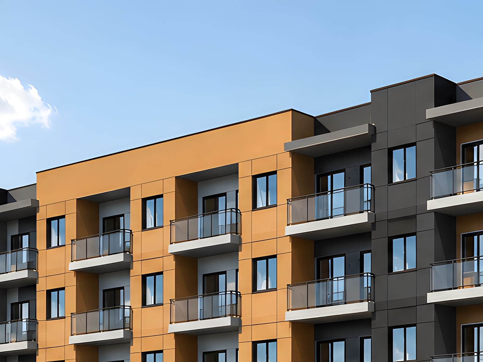 Amber and charcoal cladding across a run of balconies at Gorman