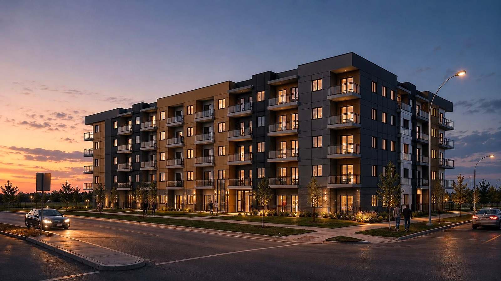 The rental building at Gorman at dusk, five storeys of charcoal and amber cladding on a corner site with lit suites above the street